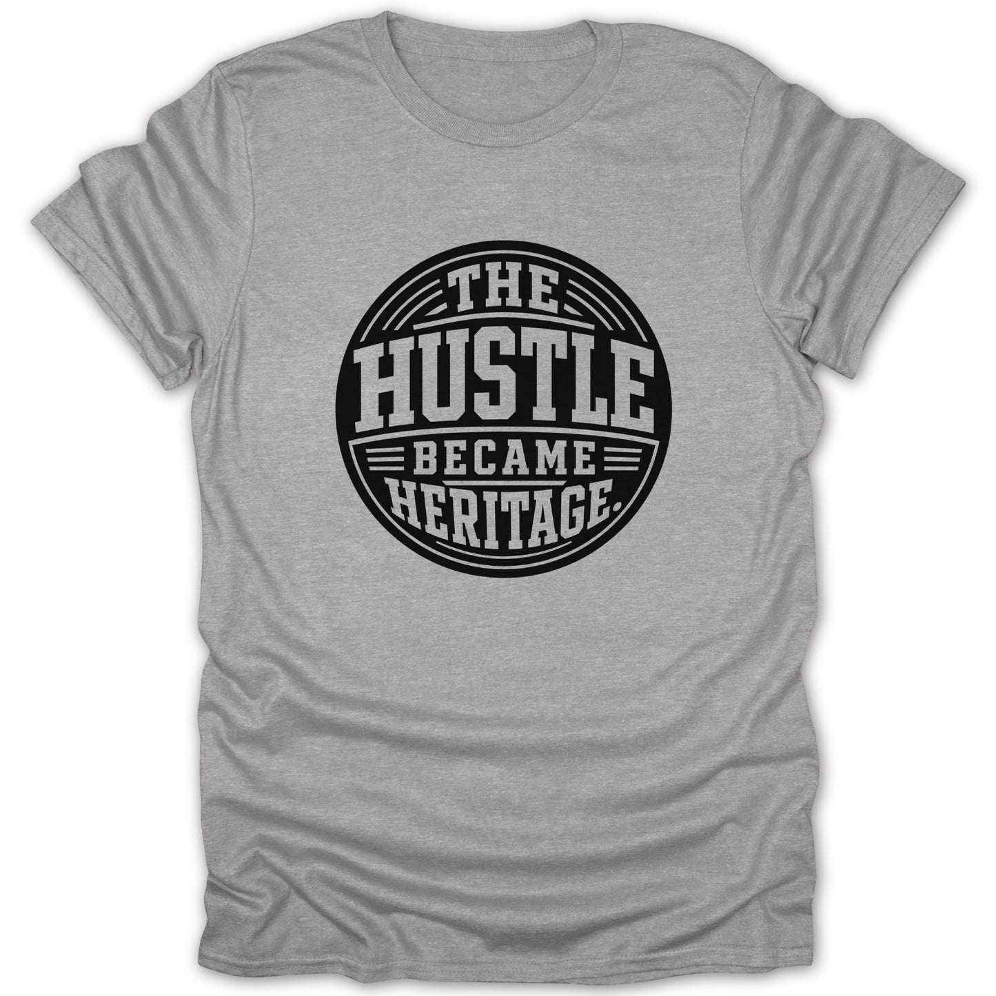 Grey t-shirt with a black circular graphic reading "The Hustle Became Heritage".