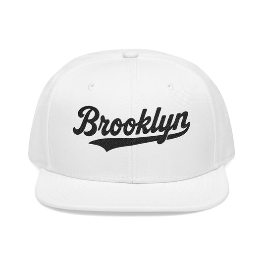 White baseball cap with "Brooklyn" written in black script.