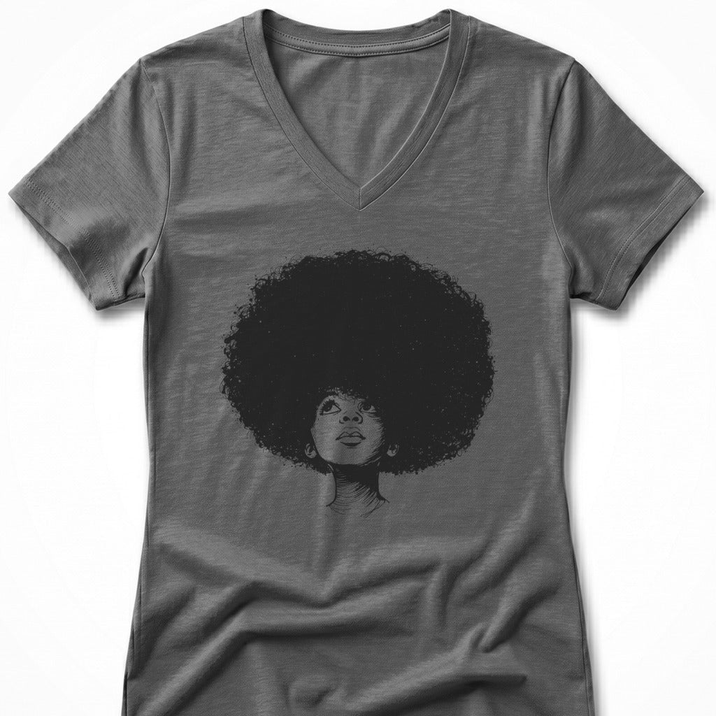 Woman with large afro looking up, charcoal sketch on gray v-neck shirt.