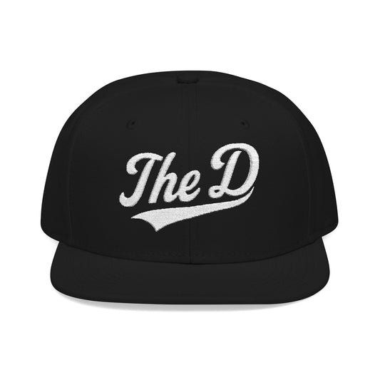 Black snapback hat with white "The D" embroidered logo.