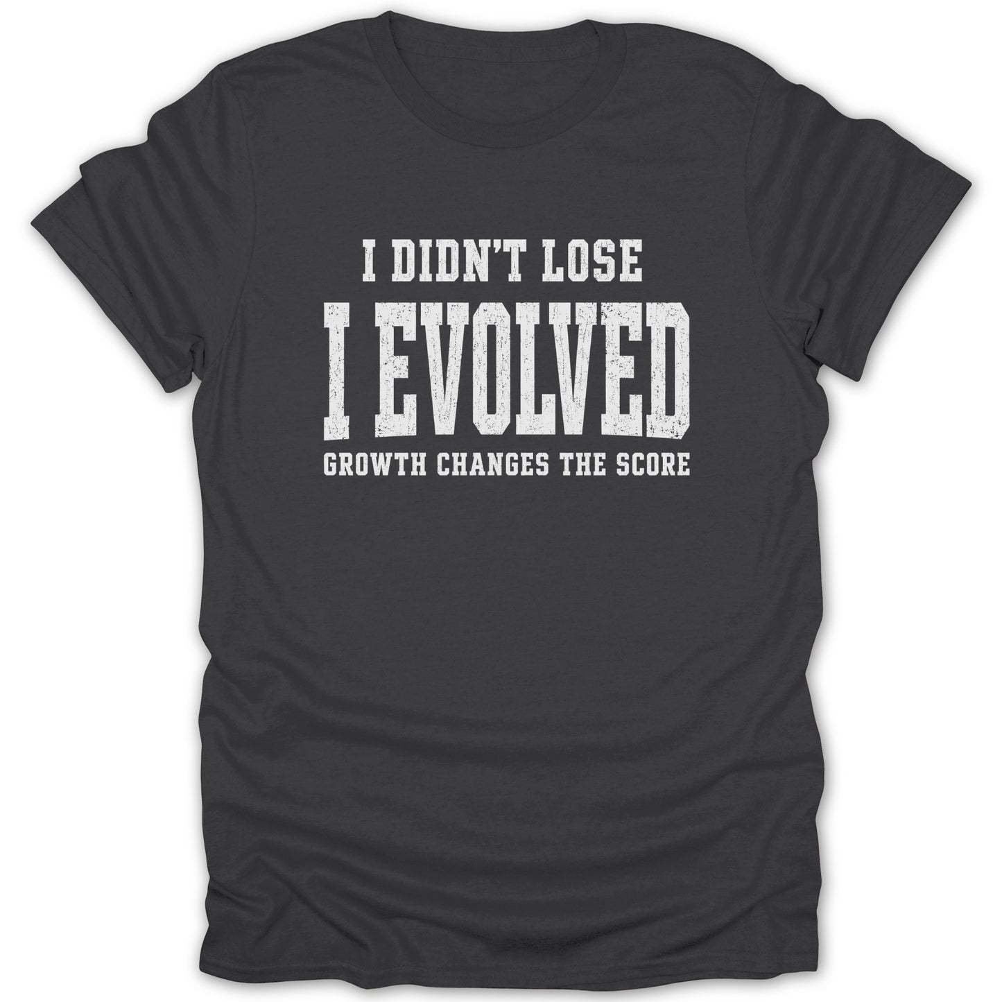 Dark grey t-shirt with white text: "I DIDN'T LOSE I EVOLVED GROWTH CHANGES THE SCORE"