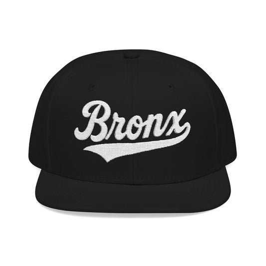 Black flat-brimmed cap with "Bronx" text in white script.