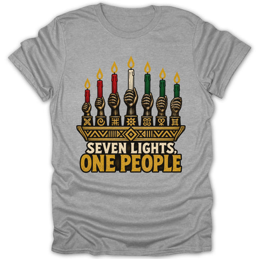 A grey t-shirt featuring a kinara graphic with raised fists holding candles and the text SEVEN LIGHTS, ONE PEOPLE.