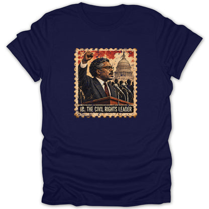 A dark blue short-sleeved t-shirt featuring a graphic of a civil rights leader at a podium with the text 18. THE CIVIL RIGHTS LEADER.