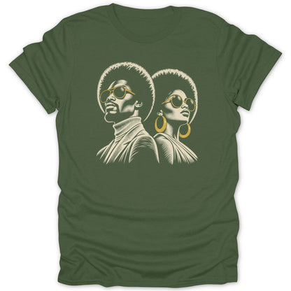 An olive green t-shirt featuring a retro graphic of a man and woman with afros and sunglasses.