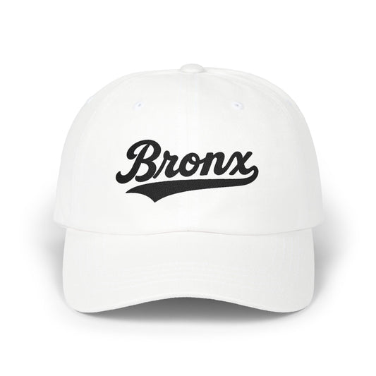 White baseball cap with "Bronx" text in black script.