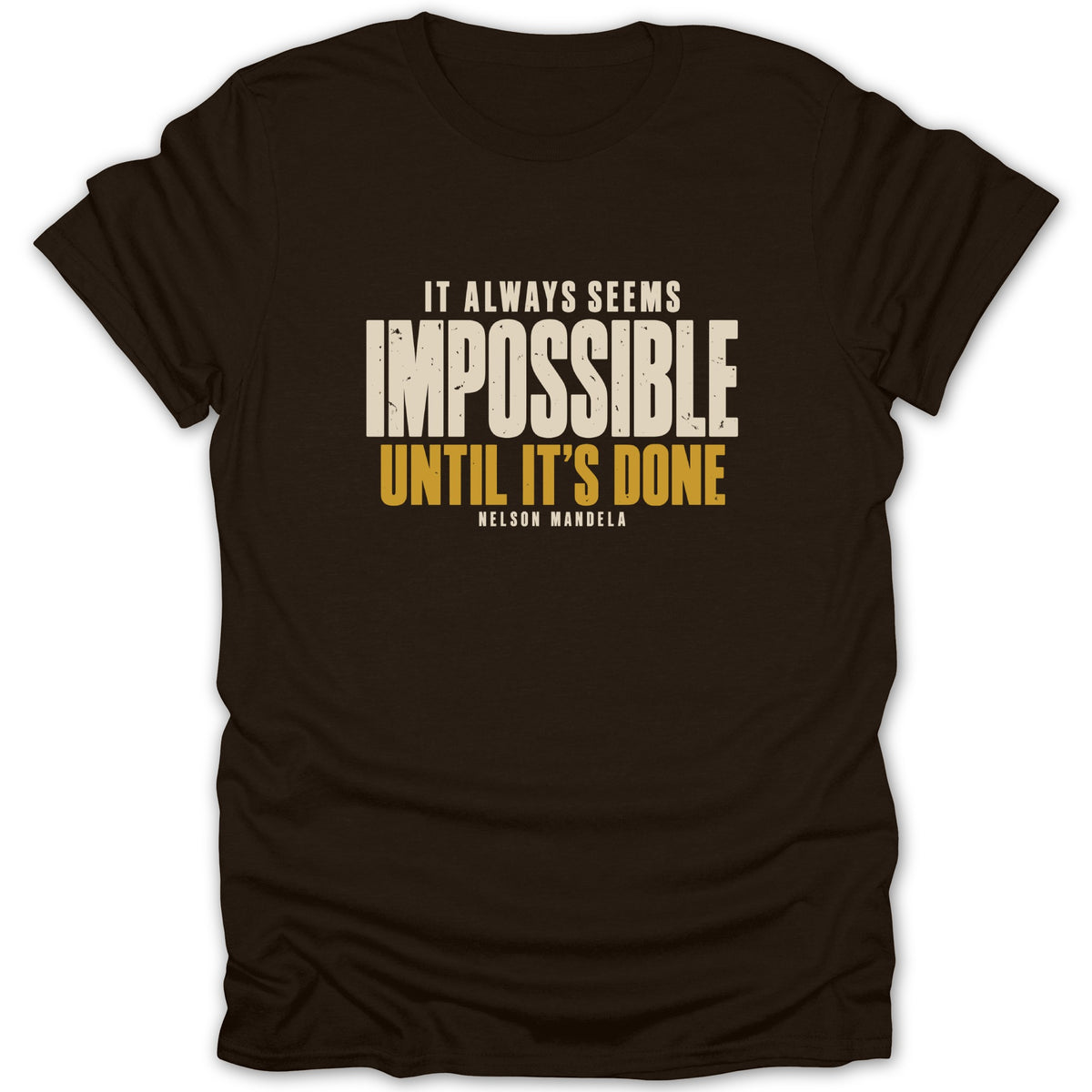 A dark brown short-sleeved t-shirt features the distressed white and yellow text, "It always seems impossible until it's done. Nelson Mandela."