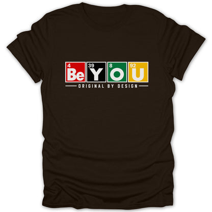 Dark brown t-shirt with "Be YOU Original by Design" text using periodic table elements.