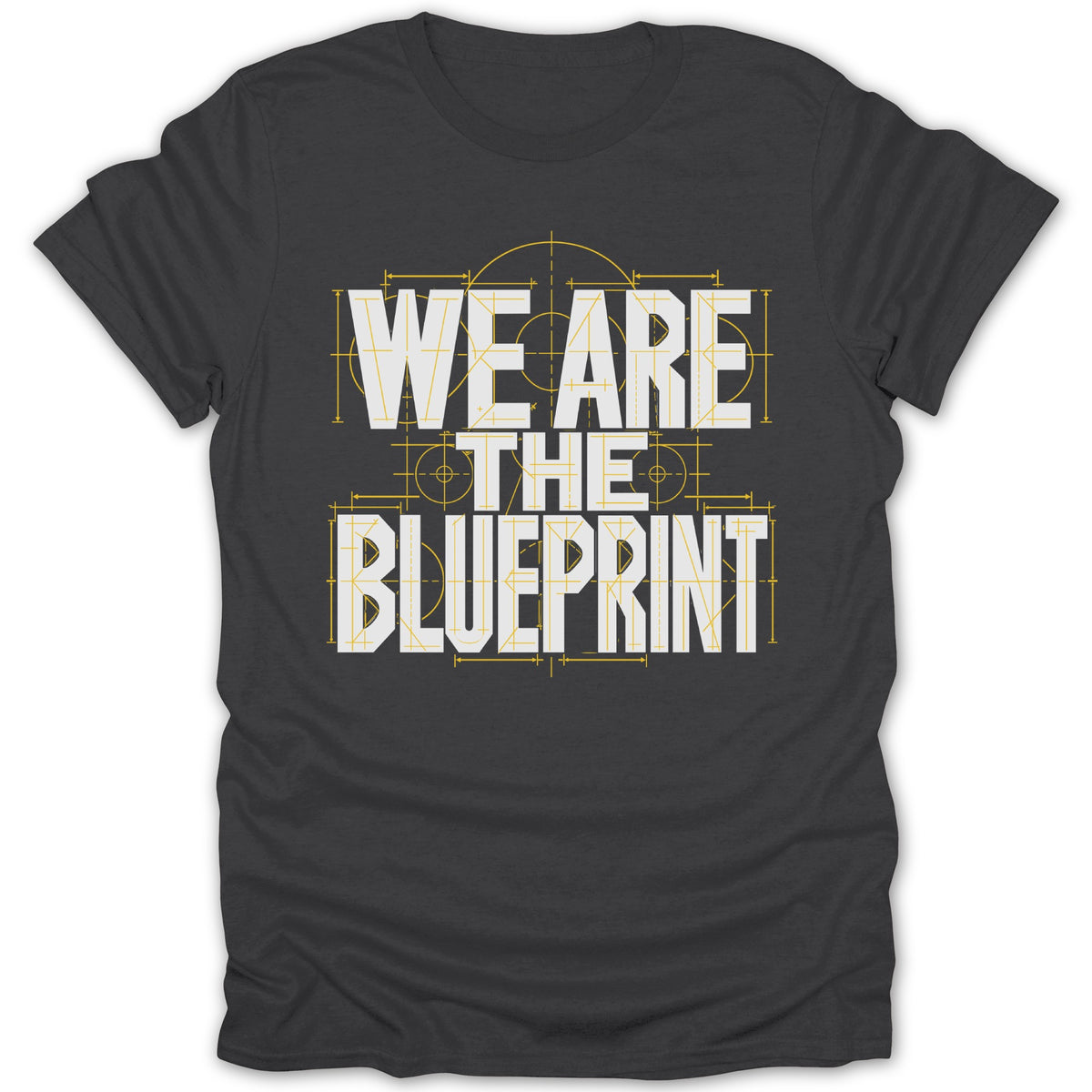 Dark grey t-shirt with white text "WE ARE THE BLUEPRINT" overlayed on a blueprint design.