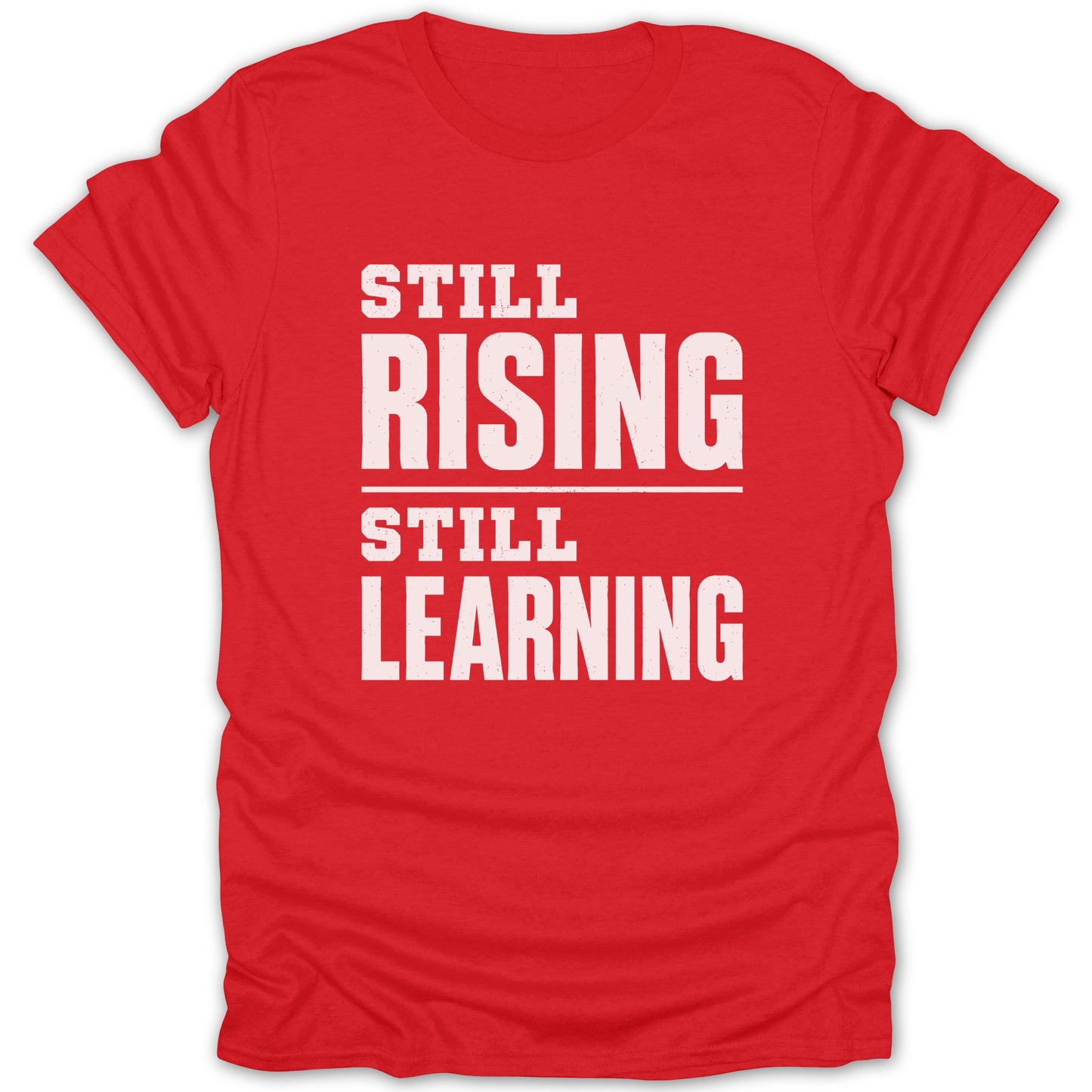 Red t-shirt with white text "STILL RISING STILL LEARNING".