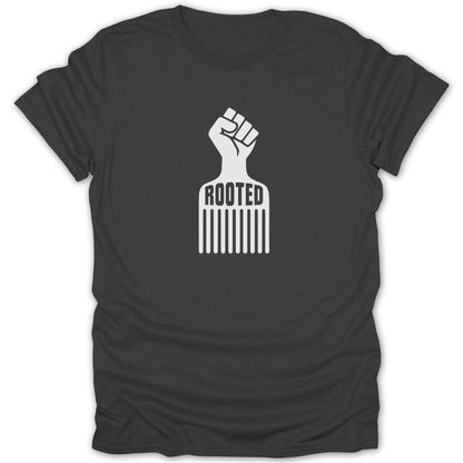 Dark gray t-shirt with a white graphic combining a raised fist and afro comb, featuring the word ROOTED.