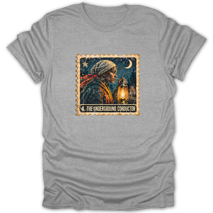 A grey t-shirt featuring a postage stamp graphic titled The Underground Conductor depicting a woman holding a lantern.