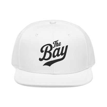 White flat-brim cap with black script text "The Bay".