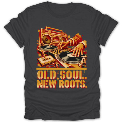 A dark gray t-shirt featuring a retro graphic of a DJ scratching records with a boombox and cassette tape, accompanied by the text OLD SOUL. NEW ROOTS.
