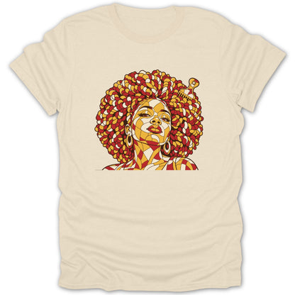 A cream-colored short-sleeved t-shirt featuring a stylized mosaic graphic of a Black woman with a large afro and an afro pick comb.