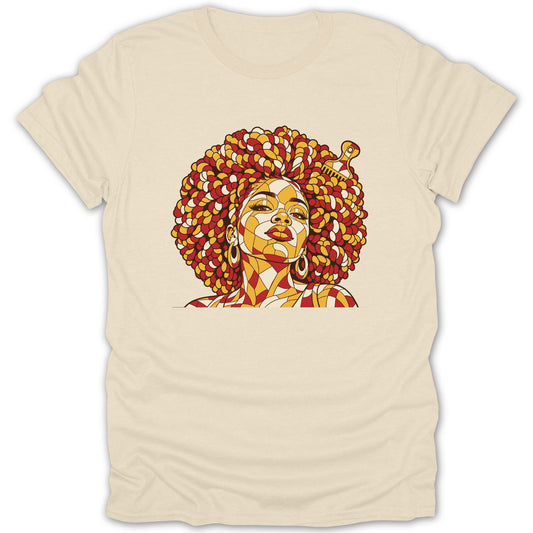 A cream-colored short-sleeved t-shirt featuring a stylized mosaic graphic of a Black woman with a large afro and an afro pick comb.