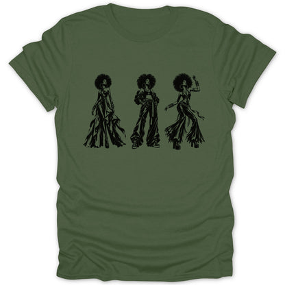 Three women with large afros and retro outfits are depicted in black ink on a green t-shirt.