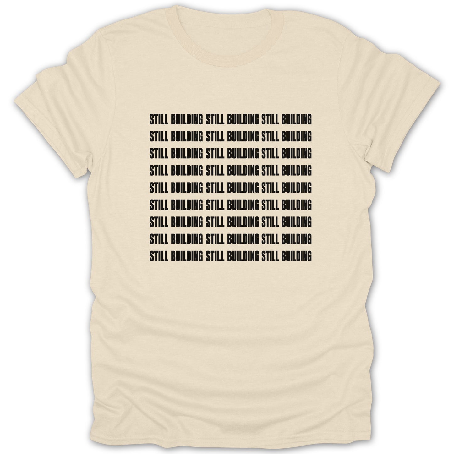 Cream t-shirt with repeated black text "STILL BUILDING".