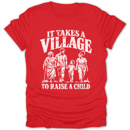 Red t-shirt featuring a white distressed graphic of a family and the text IT TAKES A VILLAGE TO RAISE A CHILD.