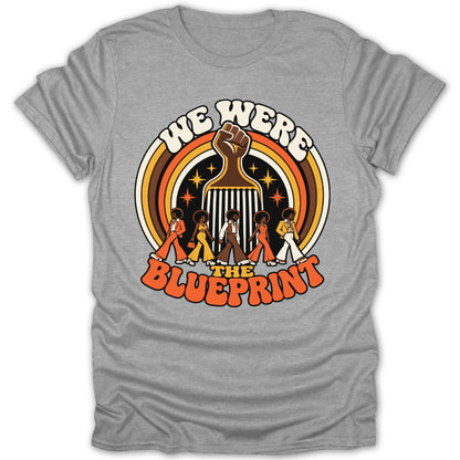 T-shirt with "We Were The Blueprint" text, fist, and retro figures.