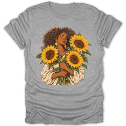 Woman holding a bouquet of sunflowers wearing a white top.