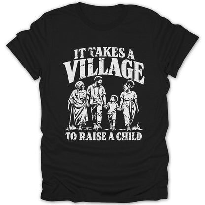 A black t-shirt featuring white distressed text that reads IT TAKES A VILLAGE TO RAISE A CHILD and an illustration of four people walking together.