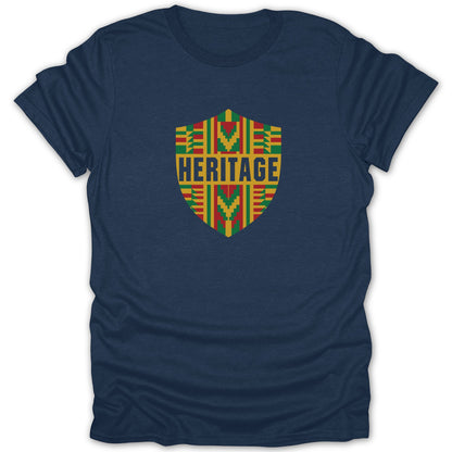 A navy blue crewneck t-shirt featuring a central crest with red, green, and yellow patterns and the word HERITAGE.