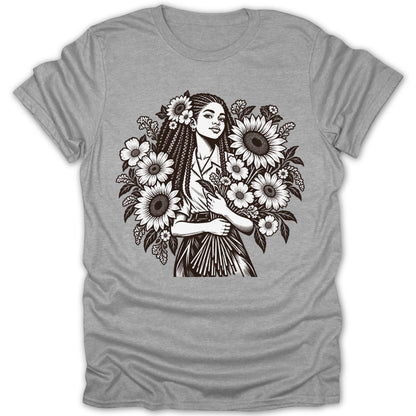 Black and white line art of a woman with braids surrounded by sunflowers on a gray t-shirt.
