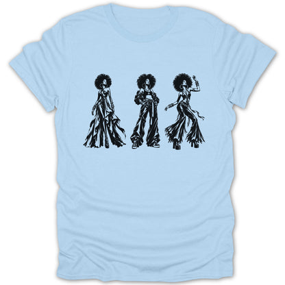 Black graphic of three women with afros and fashionable outfits on a light blue t-shirt.