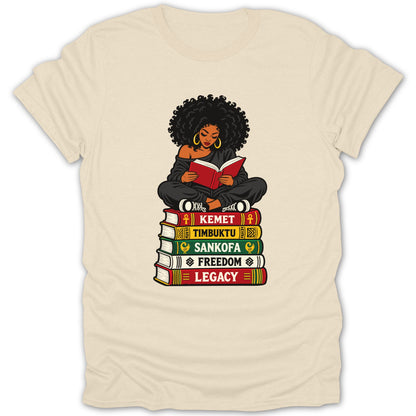 Woman reading on stack of books: Kemet, Timbuktu, Sankofa, Freedom, Legacy.