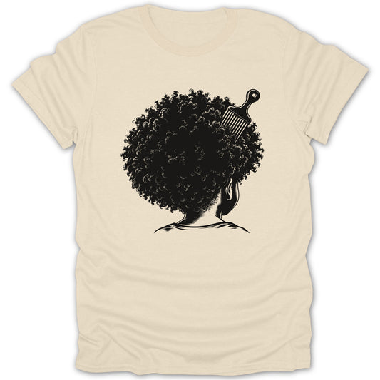 Black afro hair with a comb on a cream t-shirt.