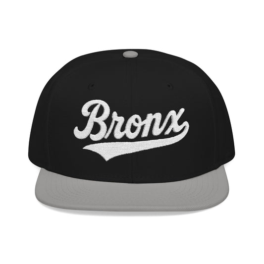 Black snapback hat with "Bronx" embroidered in white script.