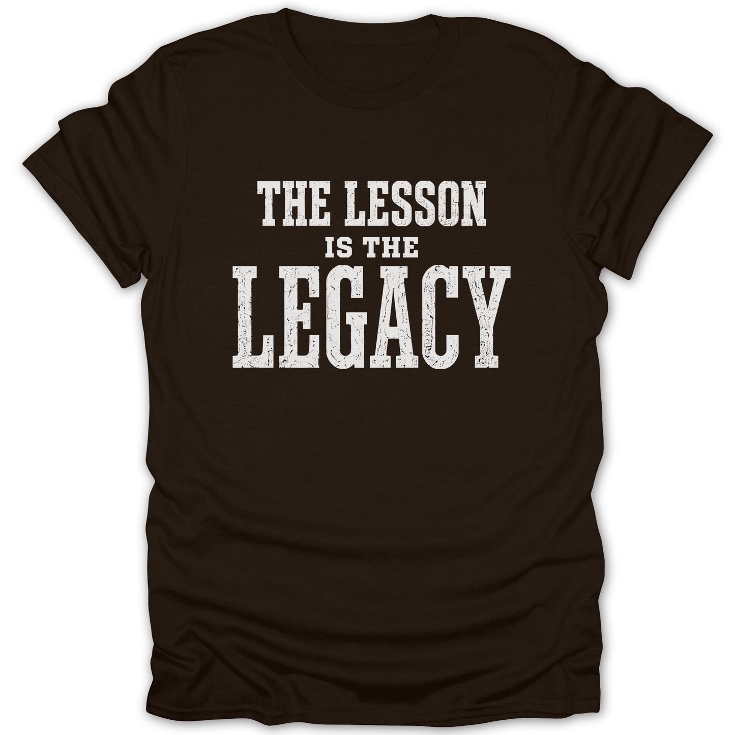 Brown t-shirt with white text reading "THE LESSON IS THE LEGACY".