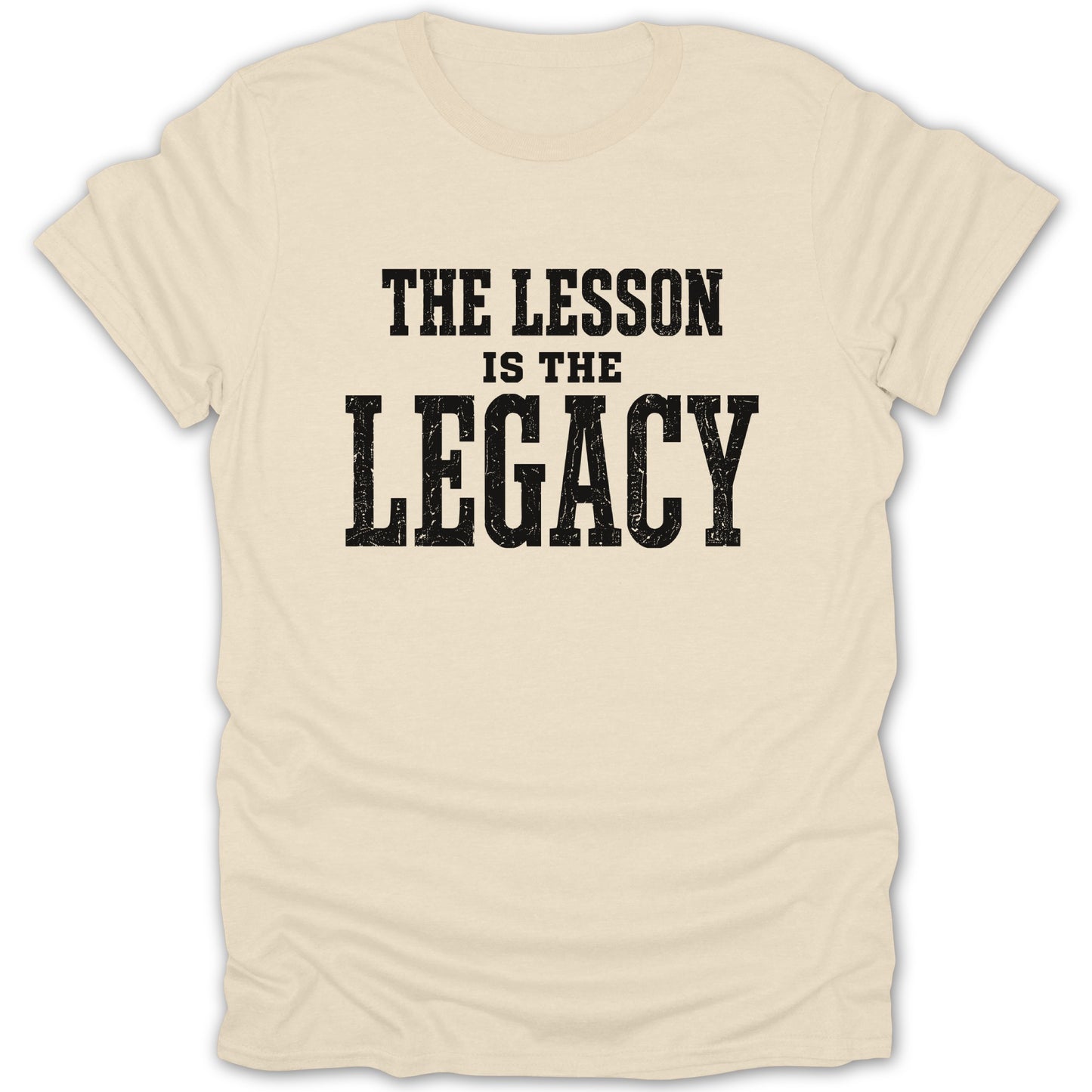 Cream t-shirt with black distressed text reading "THE LESSON IS THE LEGACY".