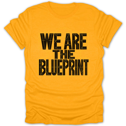 Yellow t-shirt with black text "WE ARE THE BLUEPRINT" and blueprint graphics.
