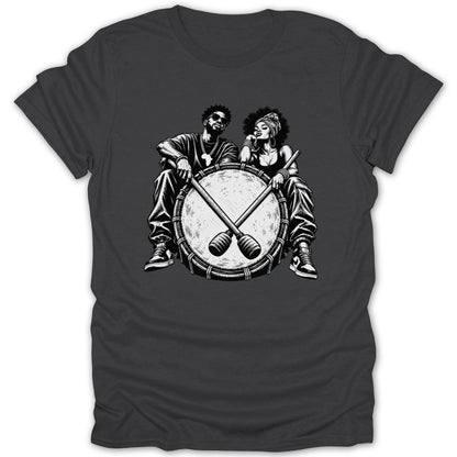 Black and white illustration of a couple sitting behind a large drum with sticks.