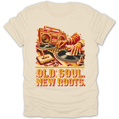 A cream t-shirt featuring a retro DJ illustration, cassette tape, boombox, and text reading OLD SOUL. NEW ROOTS.
