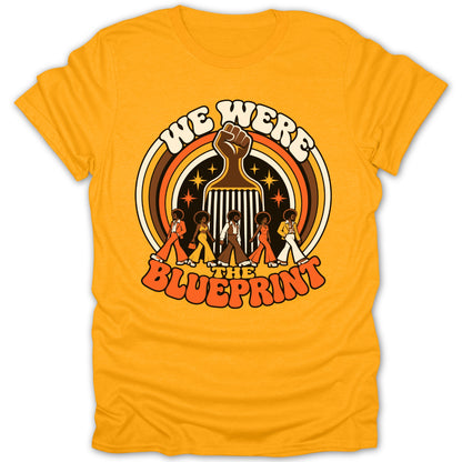 T-shirt with "We Were the Blueprint" text and retro graphic of figures and fist.