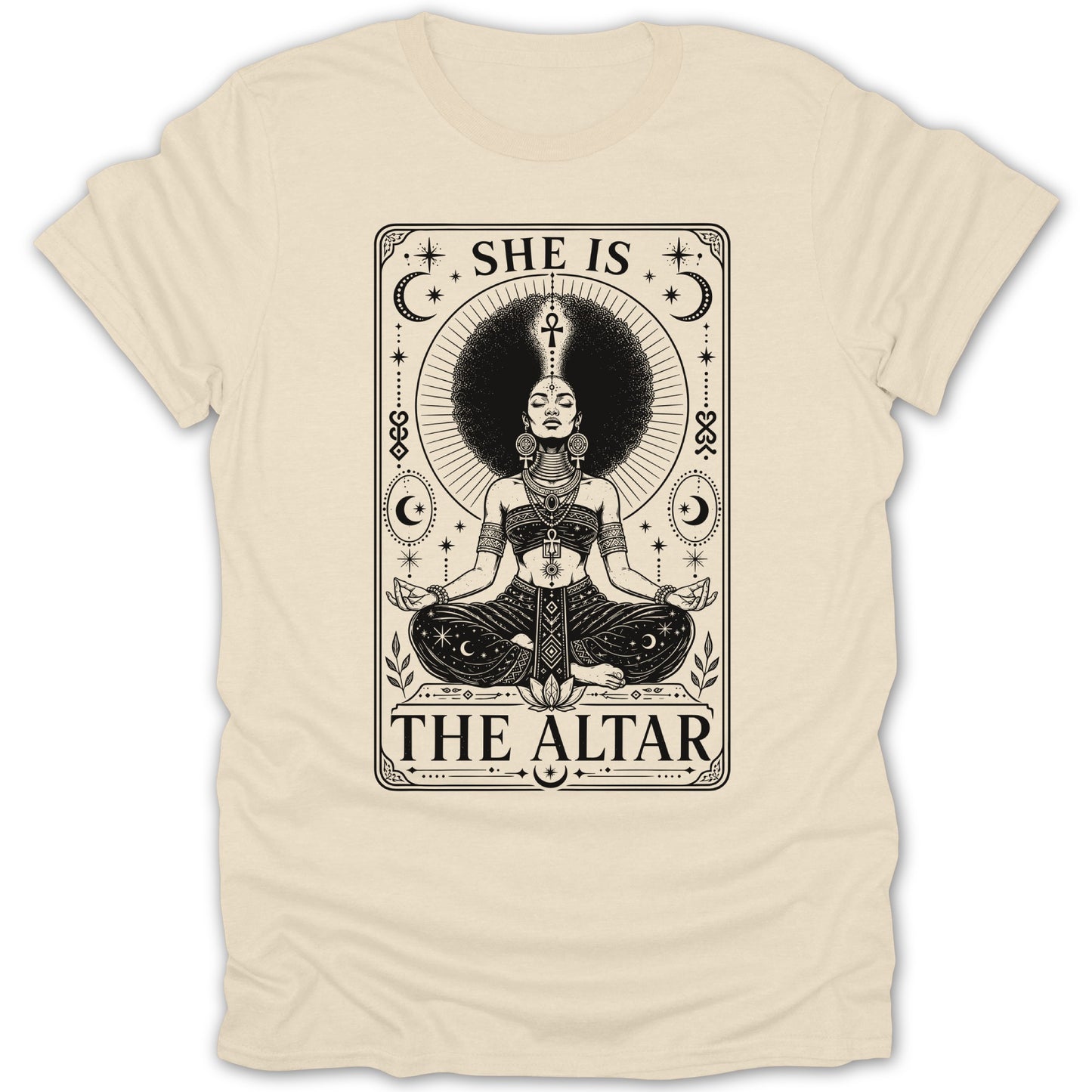 A woman with a large afro meditates on a shirt with text "SHE IS THE ALTAR".