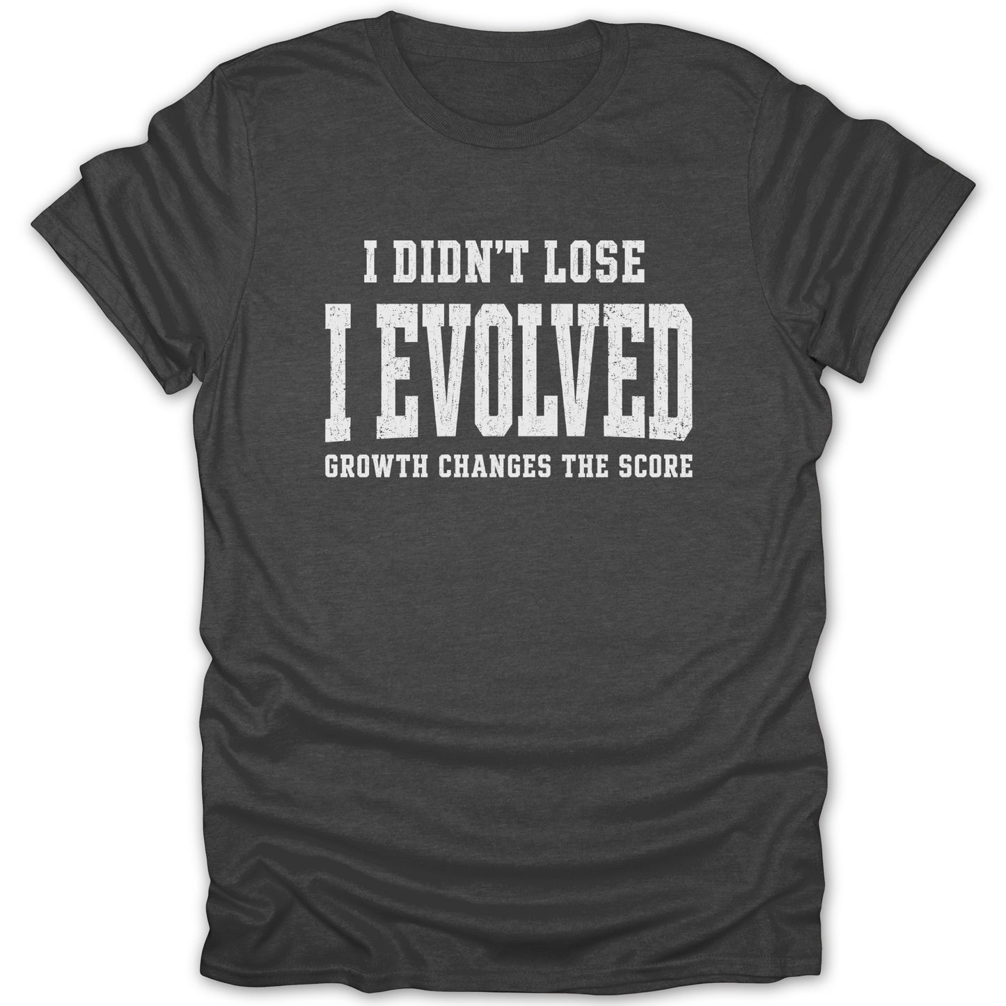 Dark gray t-shirt with white text: "I DIDN'T LOSE I EVOLVED GROWTH CHANGES THE SCORE"