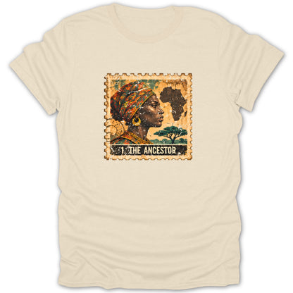 Beige crewneck t-shirt featuring a postage stamp graphic centered on the chest, depicting a woman in profile and the text THE ANCESTOR.