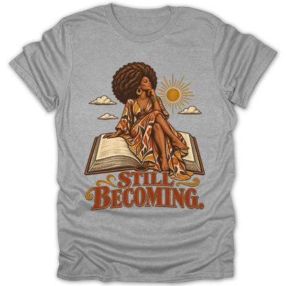 Woman with afro sitting on an open book, text "STILL BECOMING".