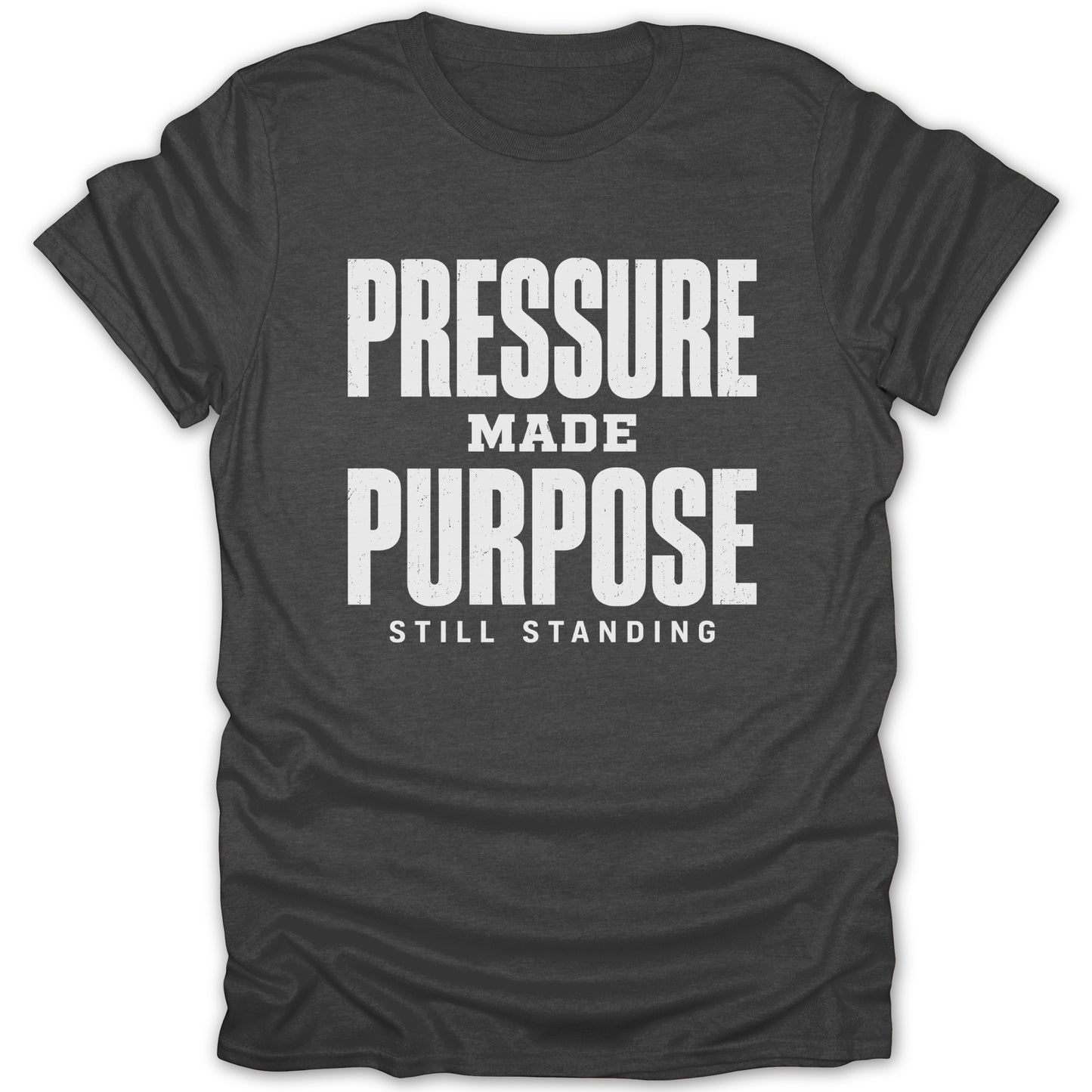Dark t-shirt with white text: "PRESSURE MADE PURPOSE STILL STANDING"
