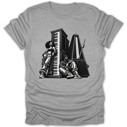 Black and white graphic of two people with a piano and metronome on a grey t-shirt.