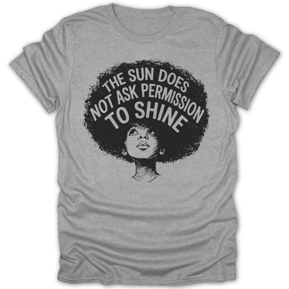 Grey t-shirt with a woman's portrait and text "THE SUN DOES NOT ASK PERMISSION TO SHINE".