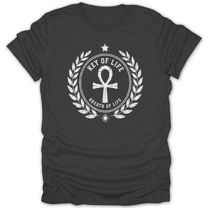 Dark grey t-shirt with a white circular crest design featuring an ankh symbol, laurel leaves, and text.