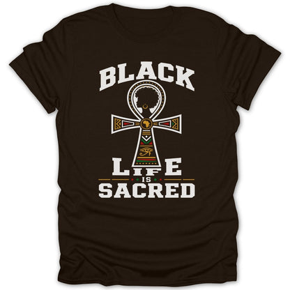 Black is sacred text on a dark brown t-shirt with an ankh symbol.