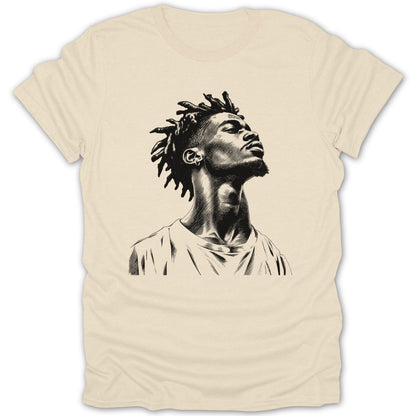 Black and white sketch of a man with dreadlocks looking up on a tan t-shirt.