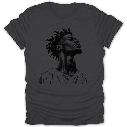 Black ink sketch of a man with dreadlocks looking upwards on a dark grey t-shirt.