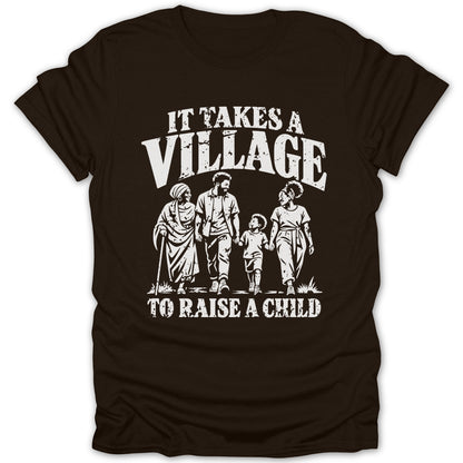 A dark brown t-shirt featuring the white distressed text "IT TAKES A VILLAGE TO RAISE A CHILD" above and below an illustration of four family members walking together.
